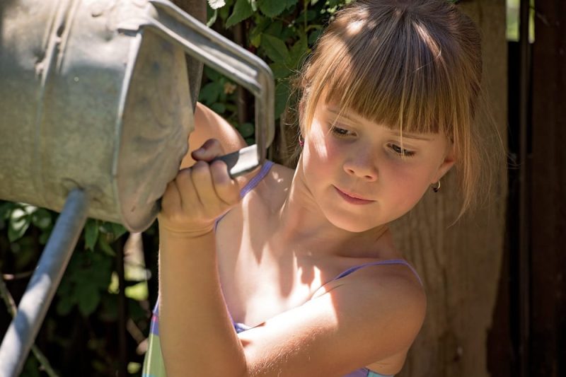 Girl watering_stock photo